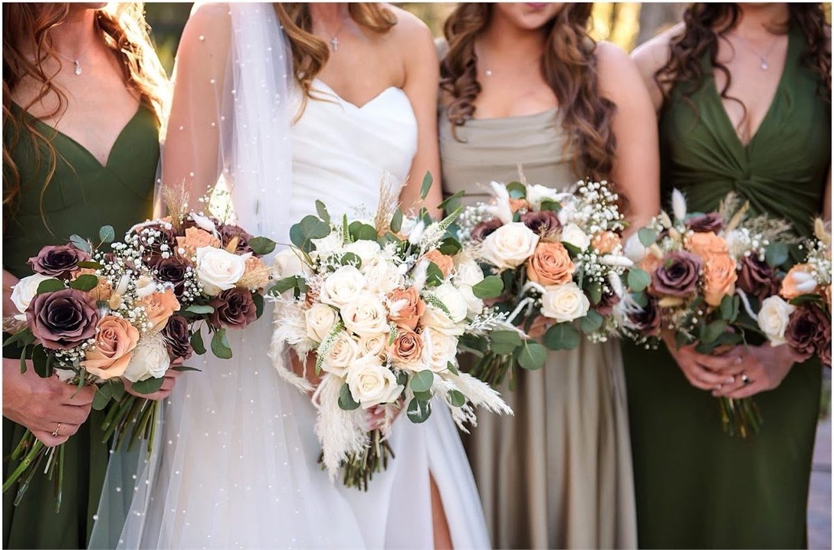 Close-up of bridal and bridesmaid bouquets in peach, plum and cream